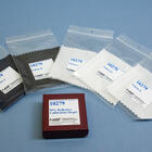 Five fabric swatches in clear plastic bags labeled 10279 are arrayed around a box labeled 99% Reflective Calibration Target. 