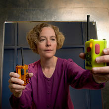 NIST engineer Kate Remley holds two Personal Alert Safety System (PASS) devices with wireless alarm capability. 