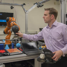 Jeremy Marvel adjusts robotic arm