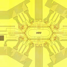 Photograph of NIST racetrack ion trap under development as possible hardware for a future quantum computer. 