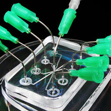 A microfluidic lab on a chip device sitting on a polystyrene dish. 