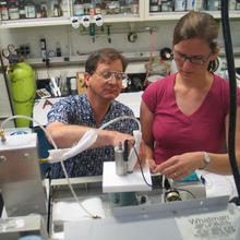 NIST research chemist Tom Bruno and postdoctoral researcher Tara Lovestead assemble an apparatus for detecting and measuring explosives and toxins.