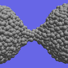 Computer simulations demonstrate the material extension and necking that occurs during the separation of amorphous silica nanoparticles.