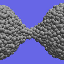 Computer simulations demonstrate the material extension and necking that occurs during the separation of amorphous silica nanoparticles.