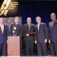 Pictured (Left to right): Commerce Secretary Don Evans; Nathaniel Moore, student, Chugach School District; Richard DeLorenzo, superintendent, Chugach School District; President Bush; Education Secretary Rod Paige.