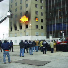 Photo of NIST firefighters performing a positive pressure ventilation test at an abandoned apartment building