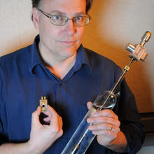 NIST physicist Samuel Benz with the two components that are compared  in the first electronic measurement of the Boltzmann constant. 