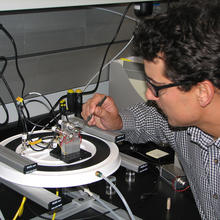 NIST chemist James Kushmerick adjusts test apparatus demonstrating a prototype silver nanoswitch.