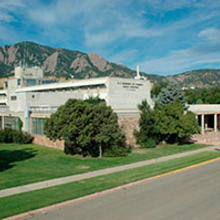 NIST Boulder Building 1, high view from left front, with Flatirons in the background.
