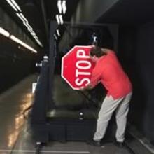 Testing how light reflects off stop signs and other road markings