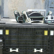 Urban search and rescue robot and its control unit sit atop one of the packing crates 