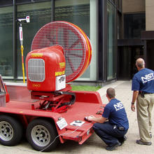 Photo of a mounted fan outside of a building