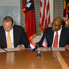 Willie May and Tjark Tjin-A-Tsoi sign an MOU