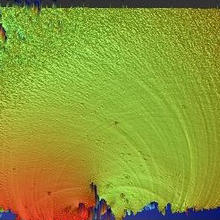 Optical profilometer image of the broken surface of a glass rod shows height of peaks and valleys of the fracture surface in millionths of a meter. 