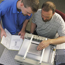 Researchers John Roberts and Oliver Slattery using the tactile graphic display device