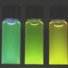Photo of brightly glowing vials of highly luminescent, water soluble quantum dots