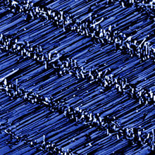 Scanning electron microscope image shows rows of horizontal zinc-oxide nanowires grown on a sapphire surface.