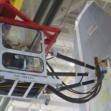 A worker in a protective cab on a NIST-developed revolutionary robotic platform