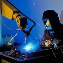 Materials research engineer James Filla monitors a welding robot.
