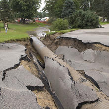 Photo of damage to a road caused by a 2007 flood in Minnesota