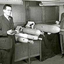 Harry Diamond holds the 81-mm mortar shell with the mortar fuze mounted on the nose.