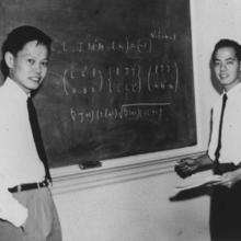 Yang and Lee in front of a chalkboard at the Institute for Advanced Study in Princeton, N.J.