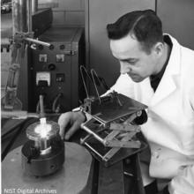 Ralph Orwick bending over a tungsten electrode welder