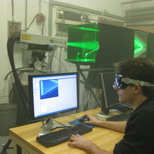 Photo of NIST scientist using Particle Image Velocimetry to measure the air flow distribution through a heat pump component.