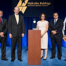 Photo of representatives from Momentum Group, DOC, NIST and the Baldrige Foundation