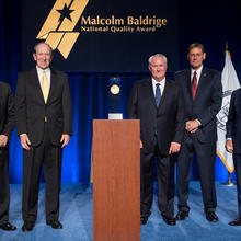 Photo of representatives from Chalmers Ford with representatives from DOC and Baldrige