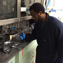 GMSE graduate student Andre Thompson in one of NIST's Fire Research laboratories, testing the flammability of materials