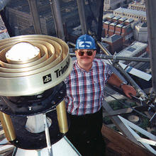 NIST Engineer stands on scaffolding at the top of the Washington Monument