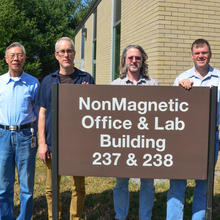 Several of the napkin signers in 2013. From left to right, Frank Seifert, Ruimin Liu, Jon Pratt, Dave Newell, Stephan Schlamminger, and Darine Haddad (+1).