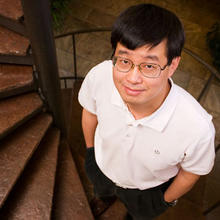 Jun Ye standing on a staircase