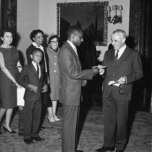 Dolphus Milligan accepting a prize from the Italian ambassador. In the background are his family members.
