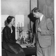 physicist Marion Langhorne Howard Brickwedde (left) and Dr. Ferdinand Brickwedde (right) with the apparatus for making heavy water between them