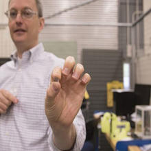 researcher in lab holding brain tissue