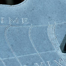 sundial in NIST Gaithersburg courtyard. The gnomon, several hour markers and the word "time" are visible. 