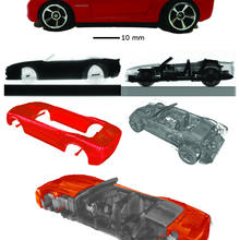 Various pieces of a red Hot Wheels car.