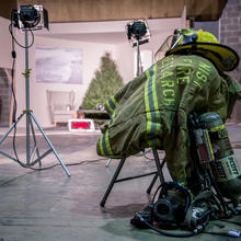 Fire hat, tank and mask and jacket sit ready for use.