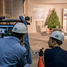 Two engineers observe the scene for the Christmas tree burn