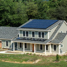 photo of a house. Solar panels on the roof.