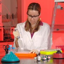 Becky Steffen pipetting liquid in a lab