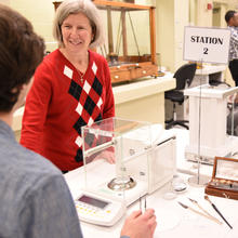 Carol Hockert stands at a table.