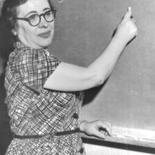 Ida Rhodes standing at a chalkboard