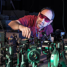 Scientists standing in front of a laser table