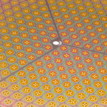 cropped image of the surface of a silicon wafer containing many rhomboidal-shaped tiles.