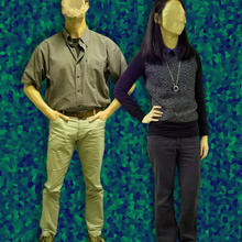 Man and woman with faces scrubbed out against an abstract backdrop.