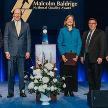 5 people standing on a stage