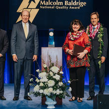 5 people standing on a stage